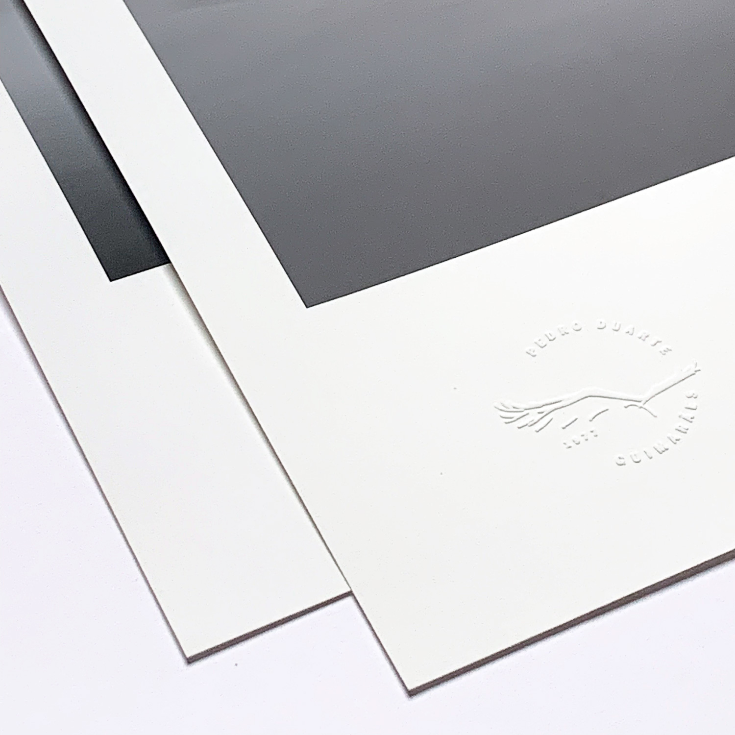 The corner of a print, blind-embossed with the studio’s seal