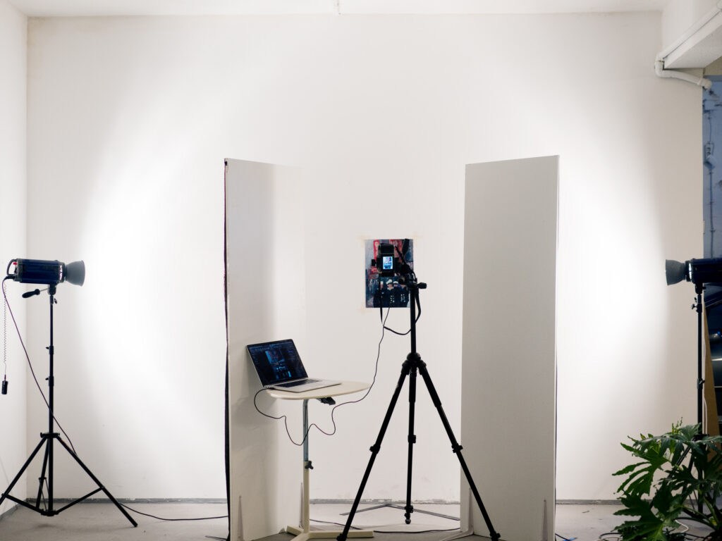Services A flat artwork being photographed for reproduction in the studio, lit by two strobes with a tethered camera